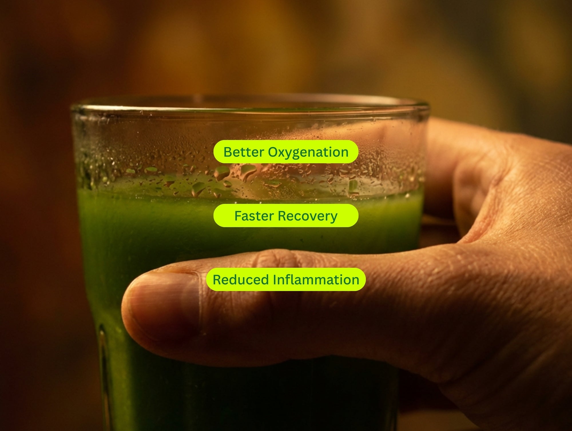 A man holding a glass of greens juice.